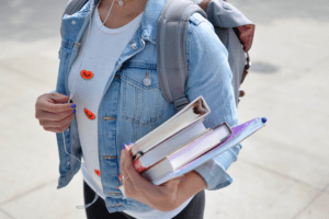 Executive Functioning: How This Life-Long Skill Benefits Your Child, image of a young student holding books with a backpack