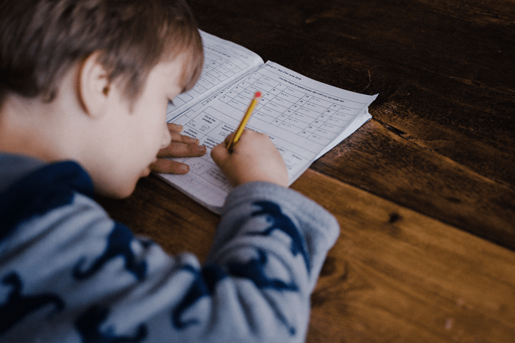 How to Help Your Child Succeed, image of a young student taking notes