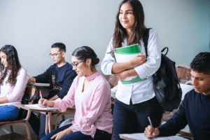 Applying for College with Learning Differences, image of a young female student in class standing up with notes in her hand