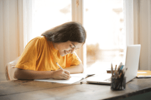 Effective Executive Function Strategies for Kids, image of a young girl writing notes.