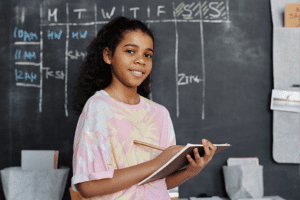 Set Your Child Up for Success on the ISEE Exam, image of a young girl studying in front of a chalkboard