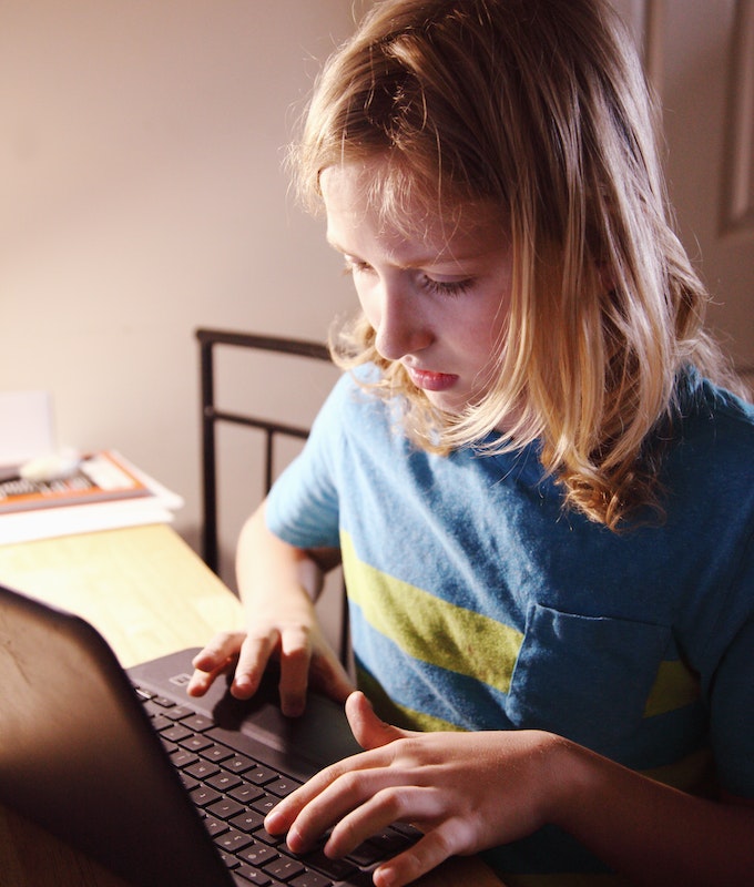 Homeschool Tutor San Diego, image of a student working at night at laptop at home.
