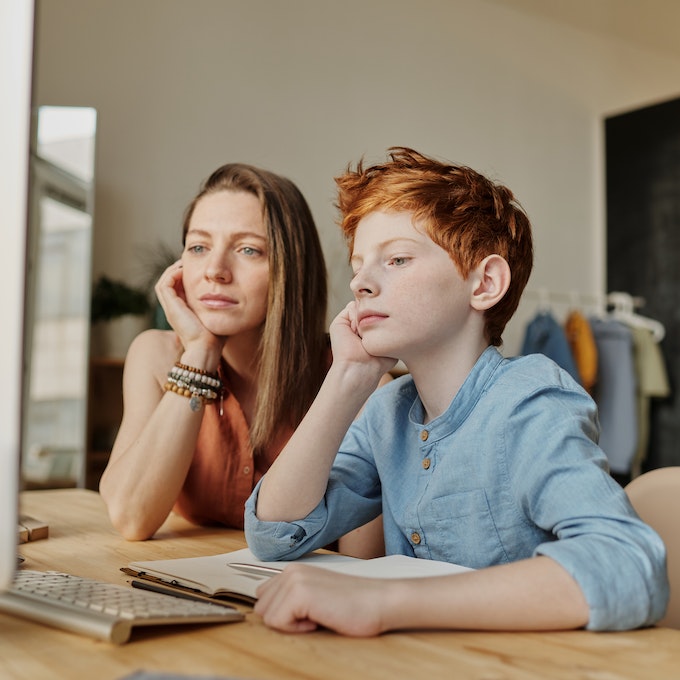 Private Homework Support Tutoring, image of mom and son with hand at their chin thinking about the homework needed to be done.