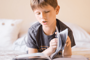 ADD/ADHD, Reading Strategy for Students with ADD/ADHD, image of a kid reading a book on a bed