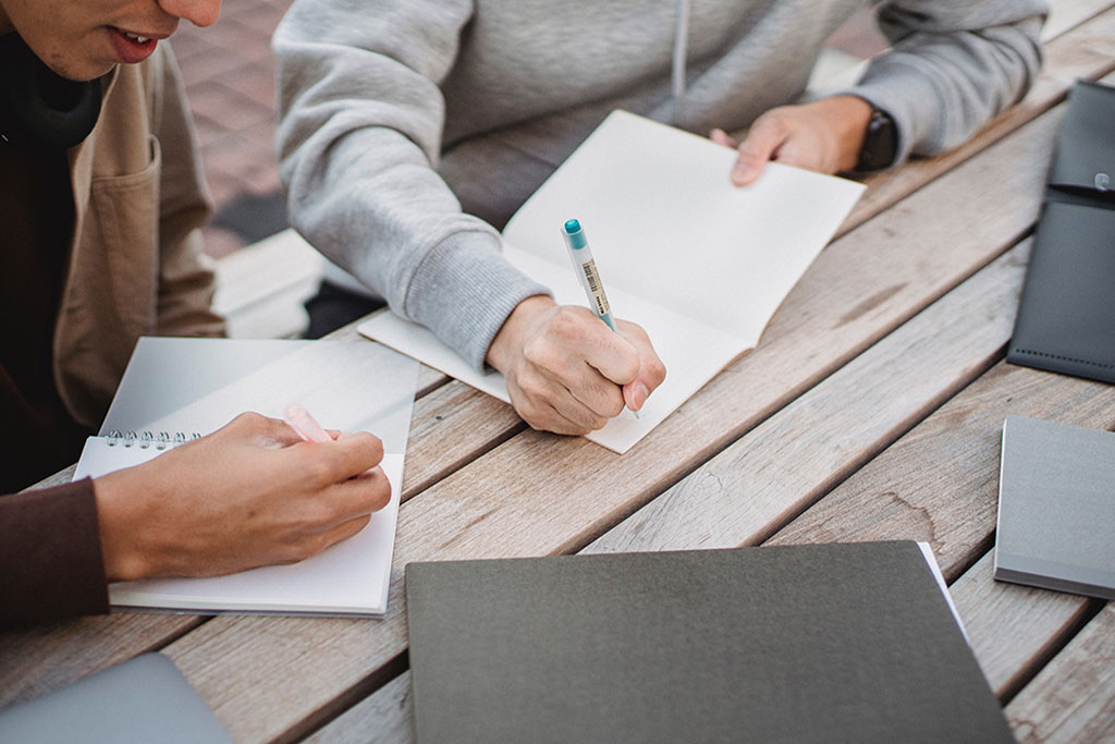 College Prep 2023: Tips for Application Essay Success, image of two teens writing their college essays