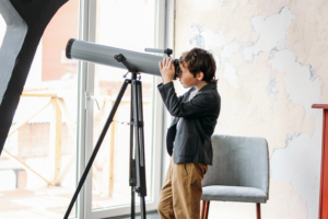 EXPLORE! Tailoring Education to Foster Genuine Interest and Beyond, image of kid looking through telescope