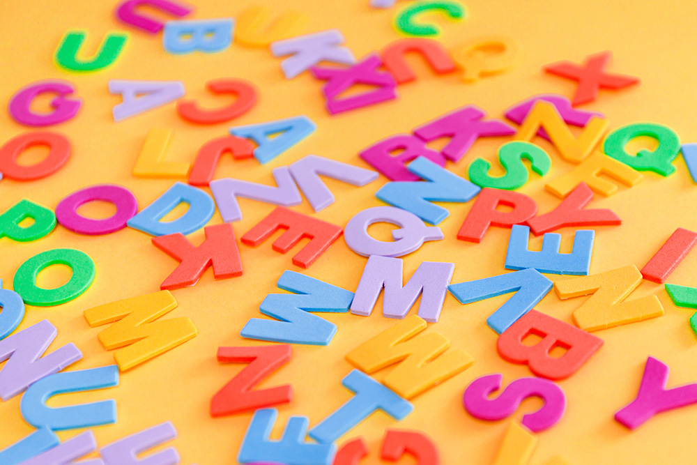 10 Spelling Tricks that You WIsh You Knew as a Kid, images of letters on the table.